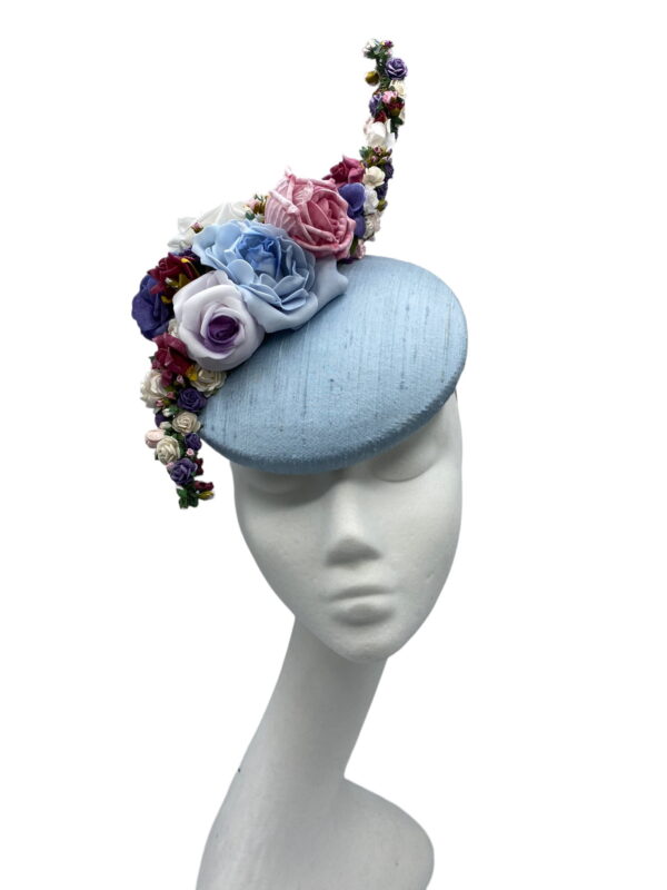 Ice blue raw silk headpiece with an array of coloured flowers.